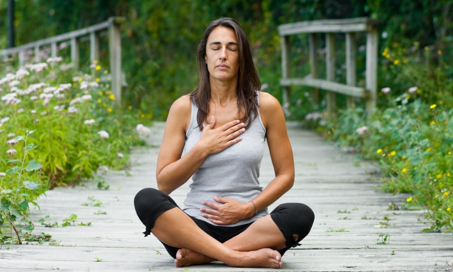 Photo of woman meditating in garden