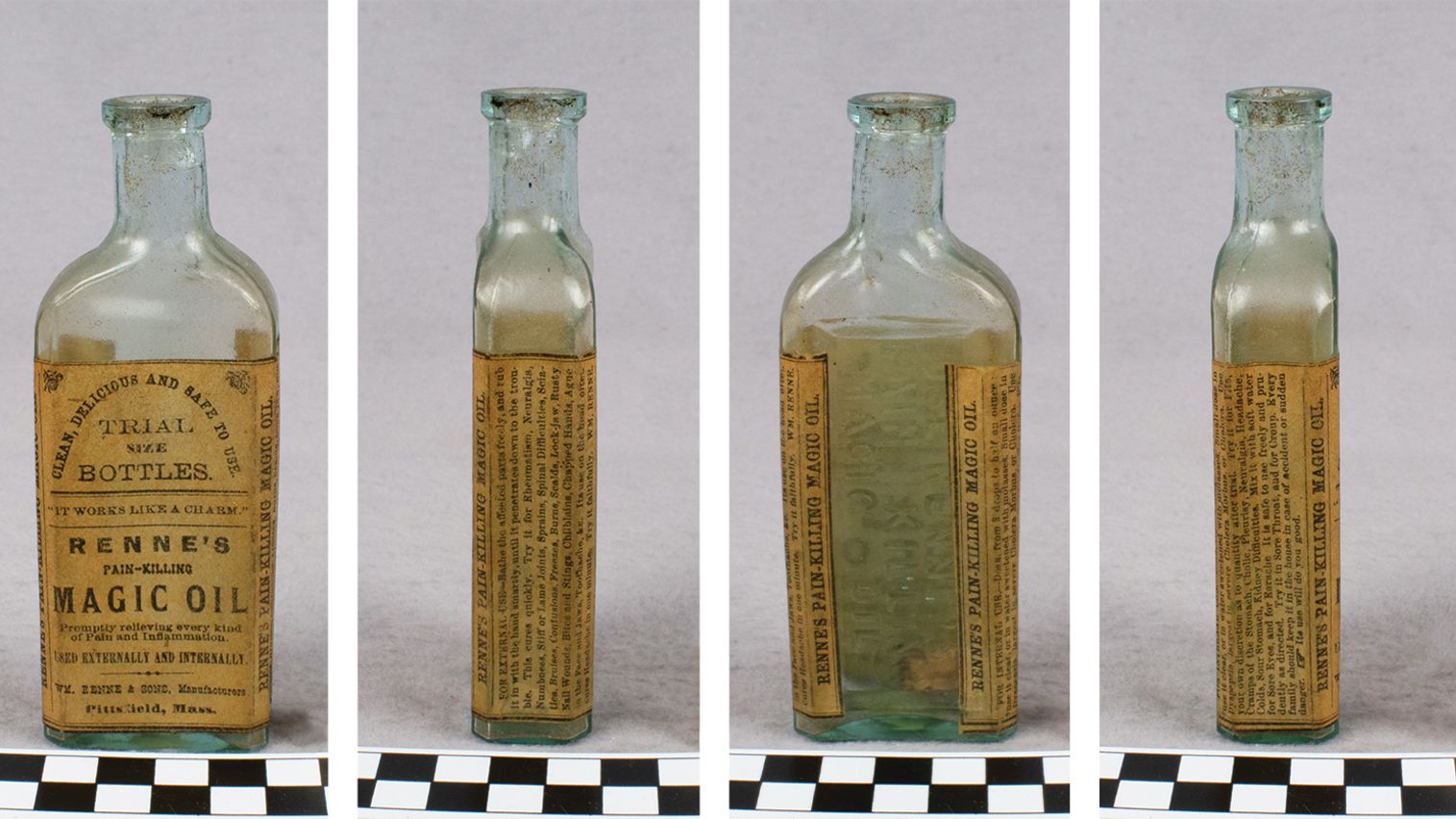 An old, empty glass bottle with a weathered brown paper label that says "Renne’s Pain-Killing Magic Oil"