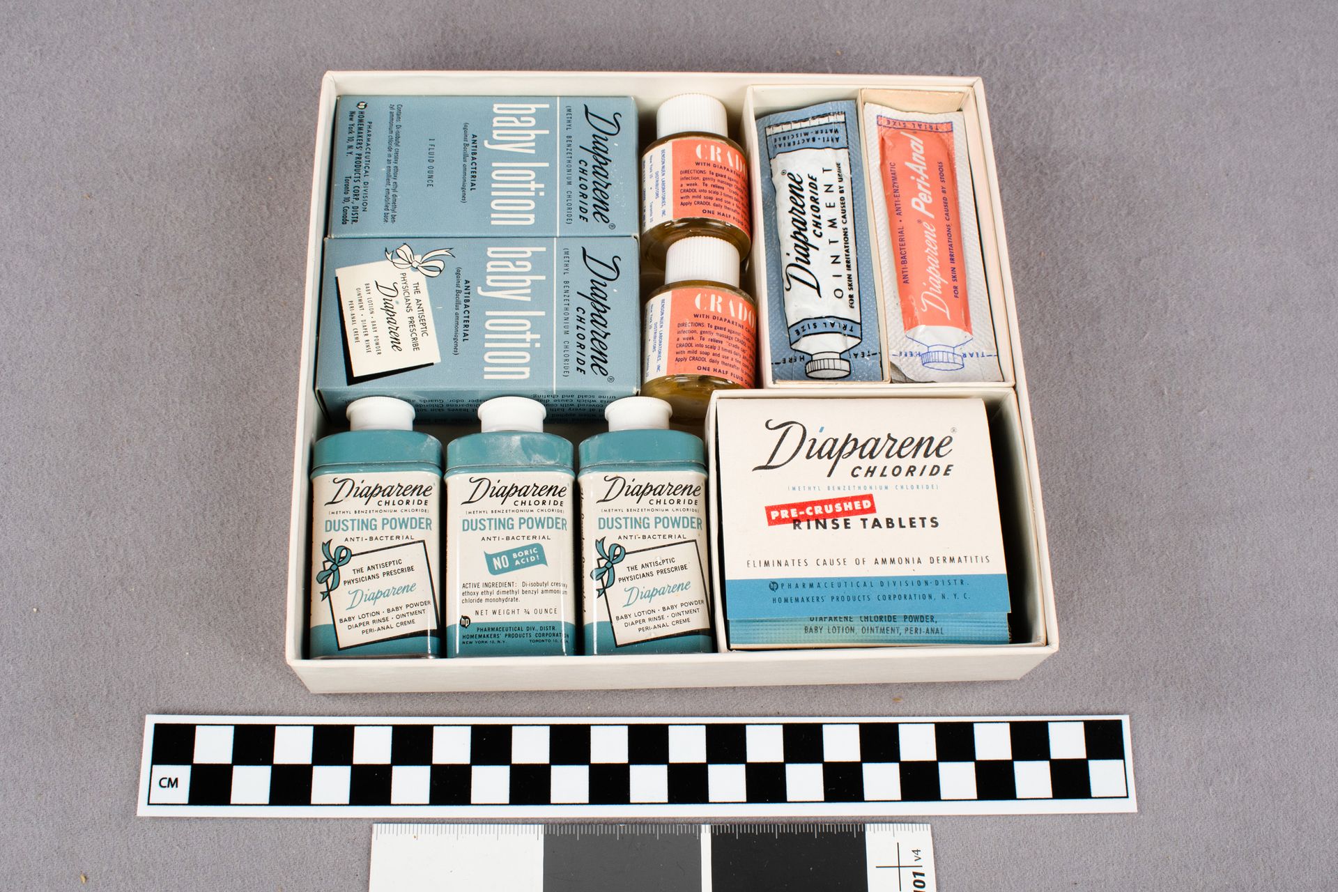 Box filled with various blue, white, and coral containers with Diaparene products