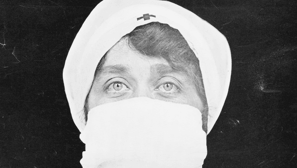 A nurse with a mask over her face.