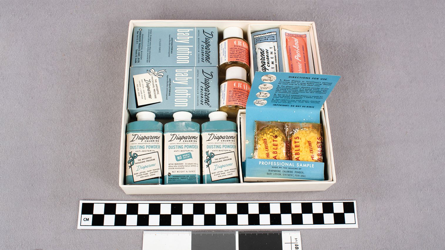 Box filled with various blue, white, and coral containers with Diaparene products