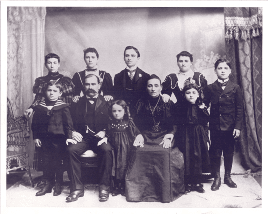 Black and white photograph of large family in period clothing