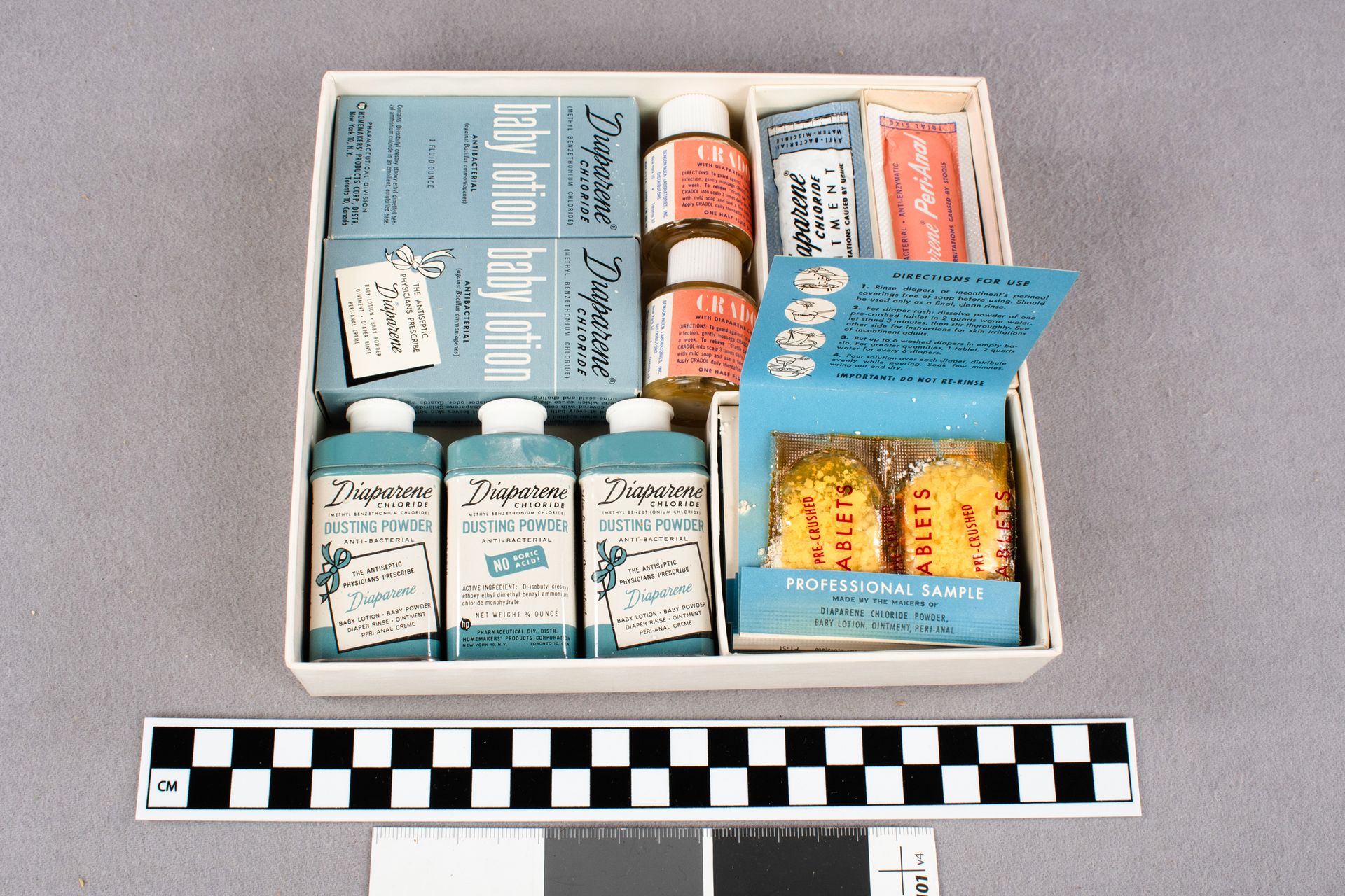 Box filled with various blue, white, and coral containers with Diaparene products