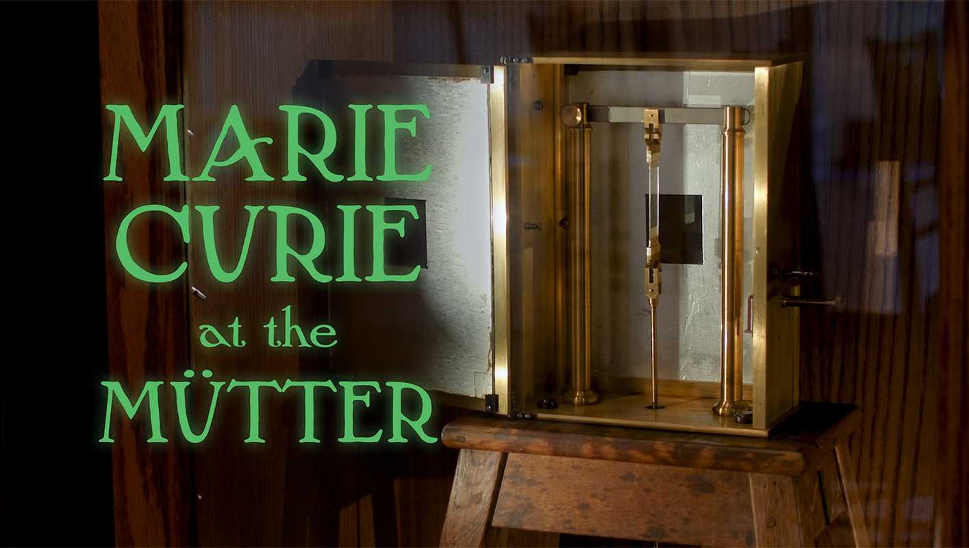 Photograph of an antique brass instrument, with text that reads "Marie Curie at the Mütter"